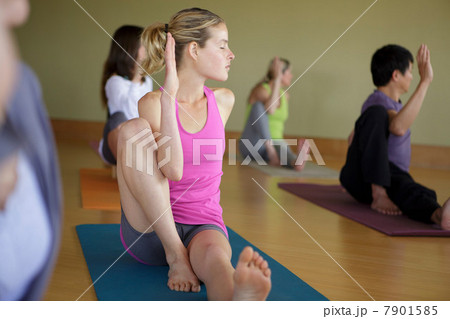 Mixed yoga group doing class in exercise studio Mixed yoga group doing class in exercise studio 7901585