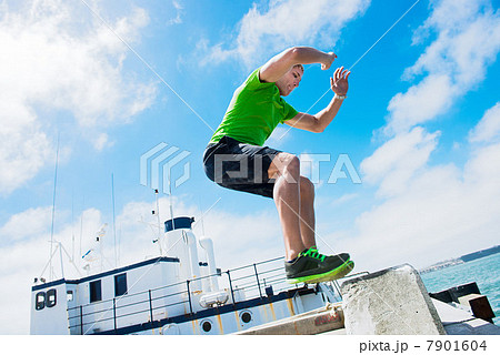 Young man jumping while fitness training 7901604