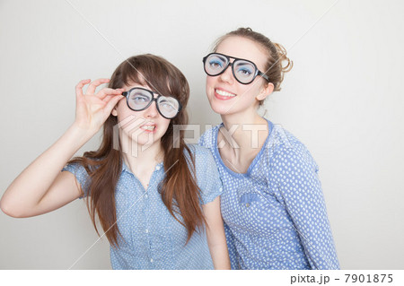 Two girls wearing fake glasses Two girls wearing fake glasses 7901875