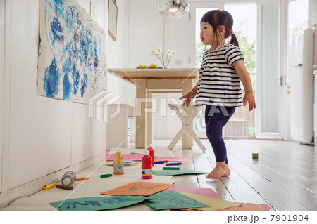 Female toddler inspecting her painting and drawing 7901904