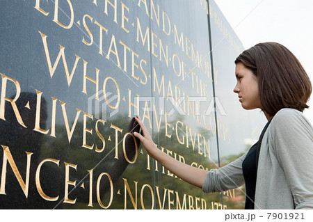 Girl looking at inscription of marine corps war memorial Girl looking at inscription of marine corps war memorial 7901921