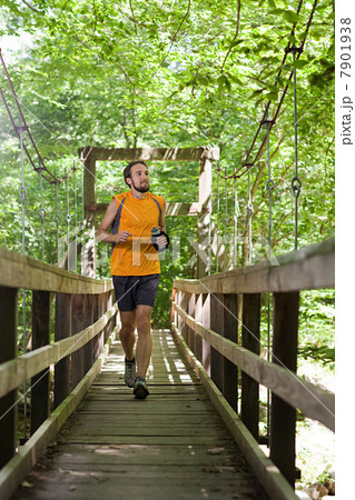 Man running along boardwalk 7901938