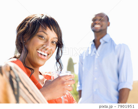 Smiling woman having wine outdoors 7901951