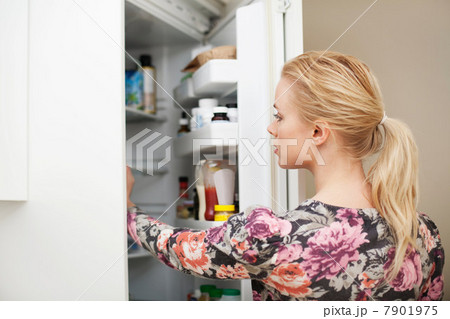 Young woman looking in refrigerator 7901975