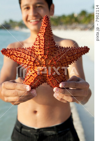 Boy holding a starfish Boy holding a starfish 7902114