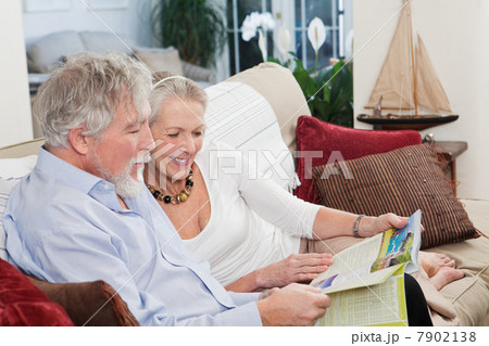 Senior couple looking at travel brochure Senior couple looking at travel brochure 7902138