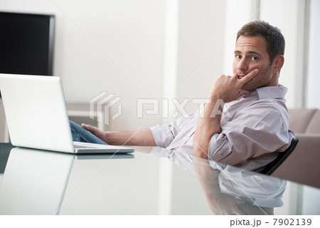 Businessman using laptop at desk Businessman using laptop at desk 7902139