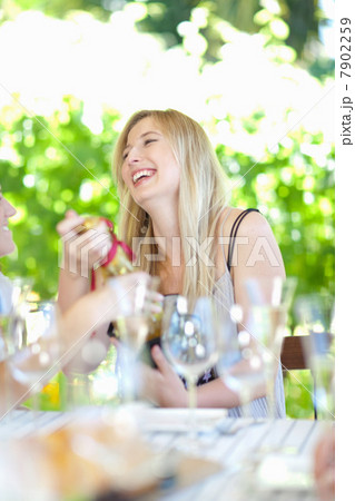 Woman opening presents at party Woman opening presents at party 7902259