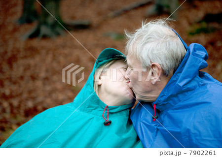 Senior couple wearing waterproofs and kissing 7902261