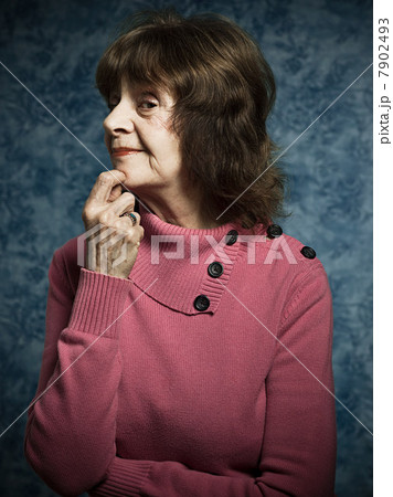 Suspicious senior woman with hand on chin 7902493