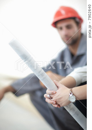 Female architect  holding blueprint 7902640