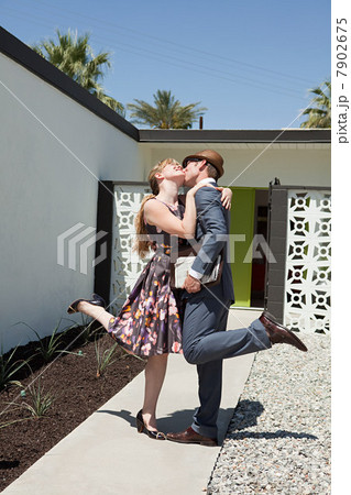 Retro couple outside home 7902675