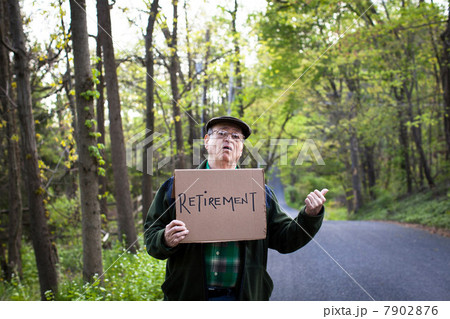 Senior man holding sign in forest, portrait Senior man holding sign in forest, portrait 7902876
