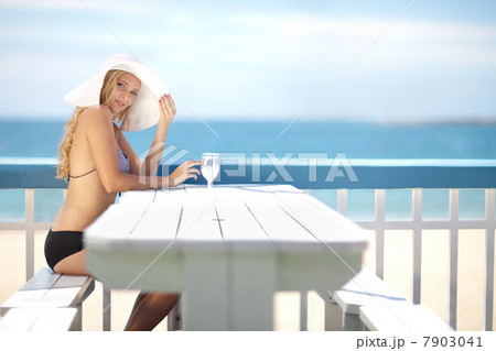 Woman sitting at table on deck 7903041
