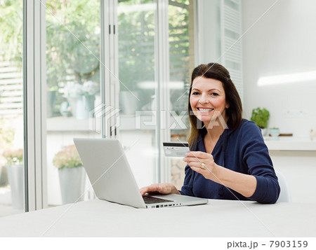 Mature woman using laptop with credit card Mature woman using laptop with credit card 7903159