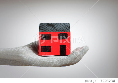 Hand holding model of house 7903238