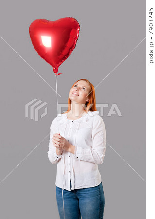 Young woman holding heart shaped balloon 7903245