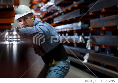 Worker using machinery in metal plant 7903295
