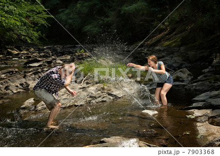 Couple playing in river 7903368