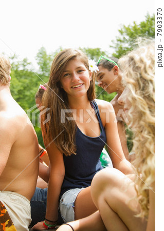 Portrait of a teenage girl sitting among friends 7903370