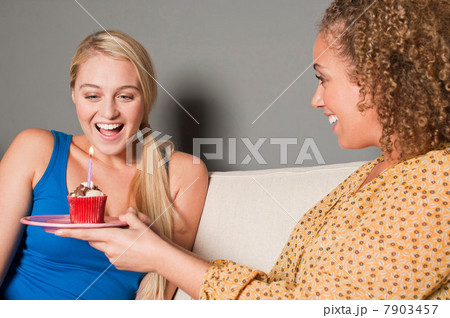 Woman giving friend cupcake Woman giving friend cupcake 7903457
