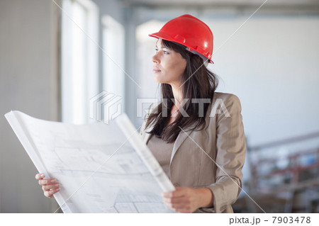 Female architect holding blueprint 7903478