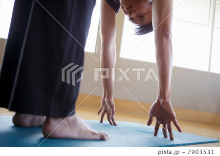Mature male practicing yoga indoors Mature male practicing yoga indoors 7903531