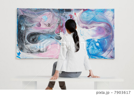 Young woman looking at oil painting in gallery Young woman looking at oil painting in gallery 7903617