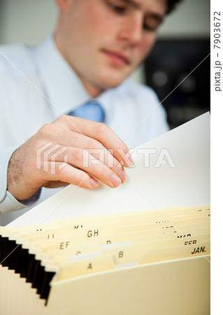 Office worker filing document 7903672