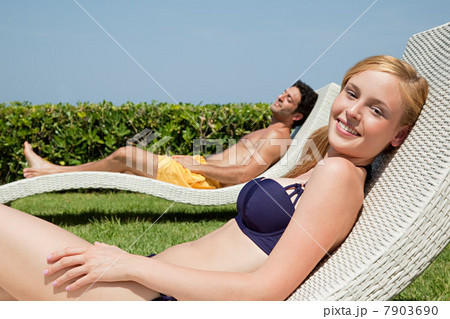 Young couple on sun loungers 7903690