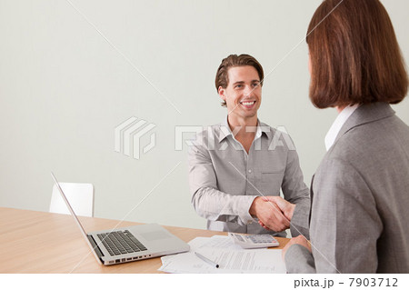 Young man shaking hands with financial adviser 7903712