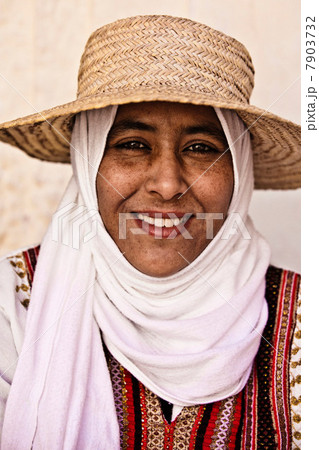 Portrait of a young woman wearing hat and headscarf in Djerba, Tunisia Portrait of a young woman wearing hat and headscarf in Djerba, Tunisia 7903732