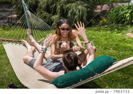 Couple in hammock, woman tickling man 7903733