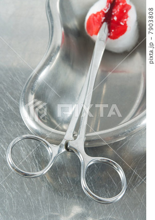 Blood on cotton swab and surgical scissors Blood on cotton swab and surgical scissors 7903808