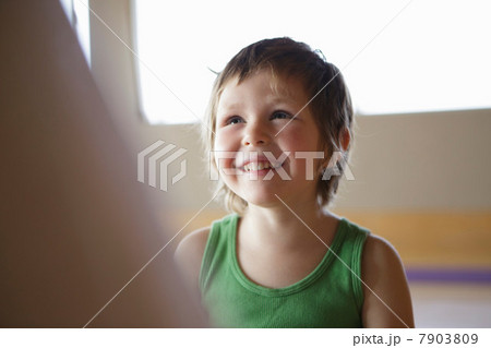 Candid portrait of smiling young girl in green vest Candid portrait of smiling young girl in green vest 7903809