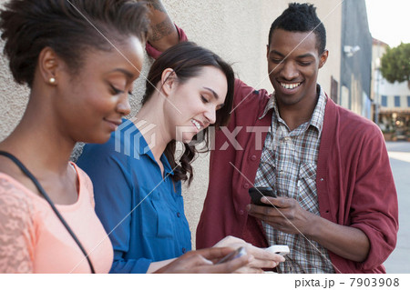 Three friends using cell phones 7903908