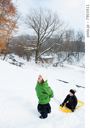 Two children sledging in snow Two children sledging in snow 7903911