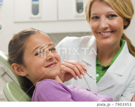 Dentist and young patient smiling, portrait Dentist and young patient smiling, portrait 7903953