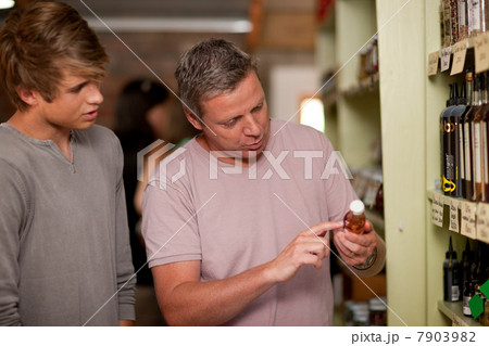 Father and son shopping for wine 7903982