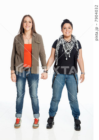 Lesbian couple holding hands against white background 7904032