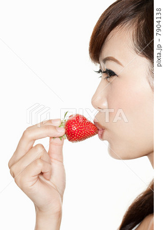 Woman kissing strawberry 7904138