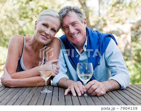 Mature couple outdoors with wine 7904139