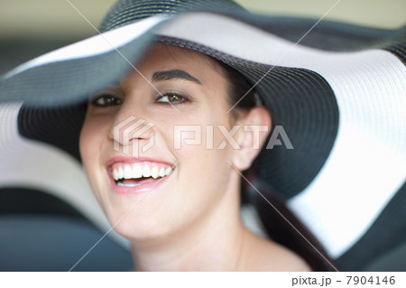 Smiling woman wearing sun hat 7904146