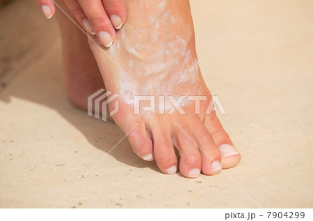 Woman moisturizing foot 7904299