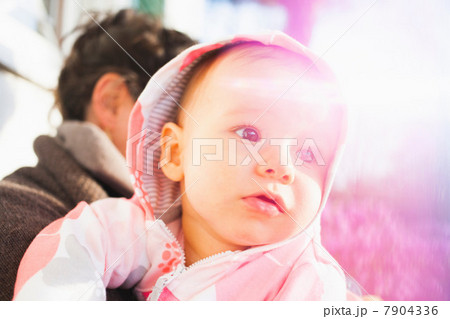 Close up portrait of baby girl wearing hood Close up portrait of baby girl wearing hood 7904336