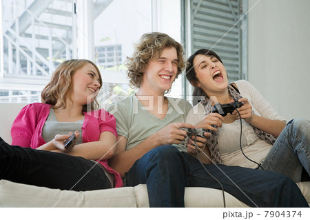 Teenagers playing on games console Teenagers playing on games console 7904374