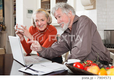 Senior couple using laptop Senior couple using laptop 7904571