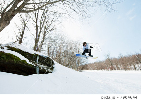 Snowboarder jumping in midair Snowboarder jumping in midair 7904644