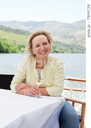 Mature woman with glass of wine on a boat holiday 7904726
