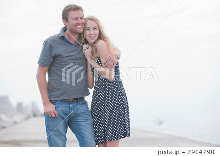 Young couple standing together on pier 7904790